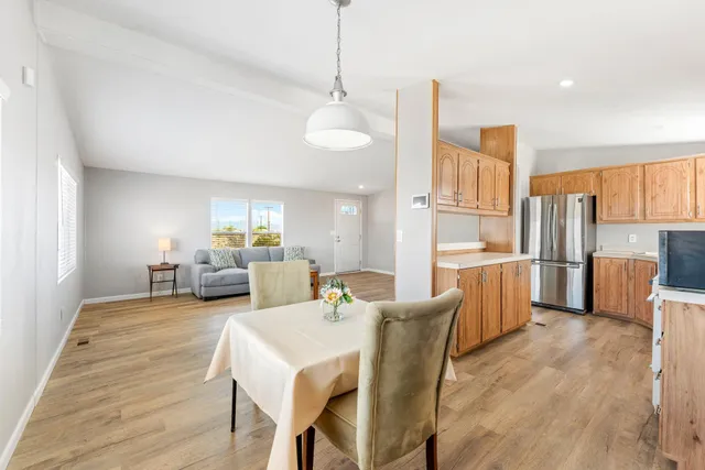 a kitchen with a sink cabinets stainless steel appliances and a window