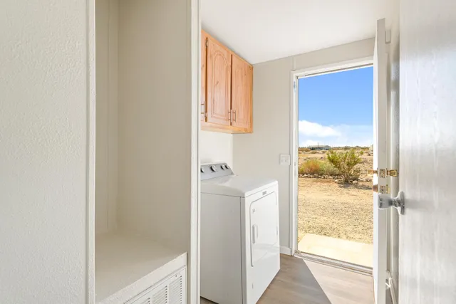 a view of a livingroom with wooden floor and a window