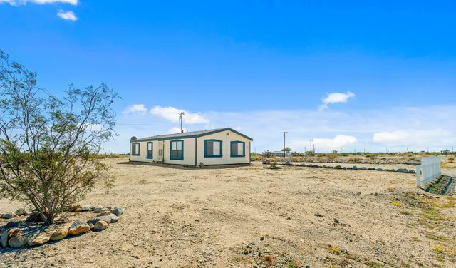 a view of a large body of water with a house in the background