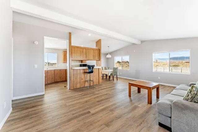 a kitchen with a table chairs and a refrigerator