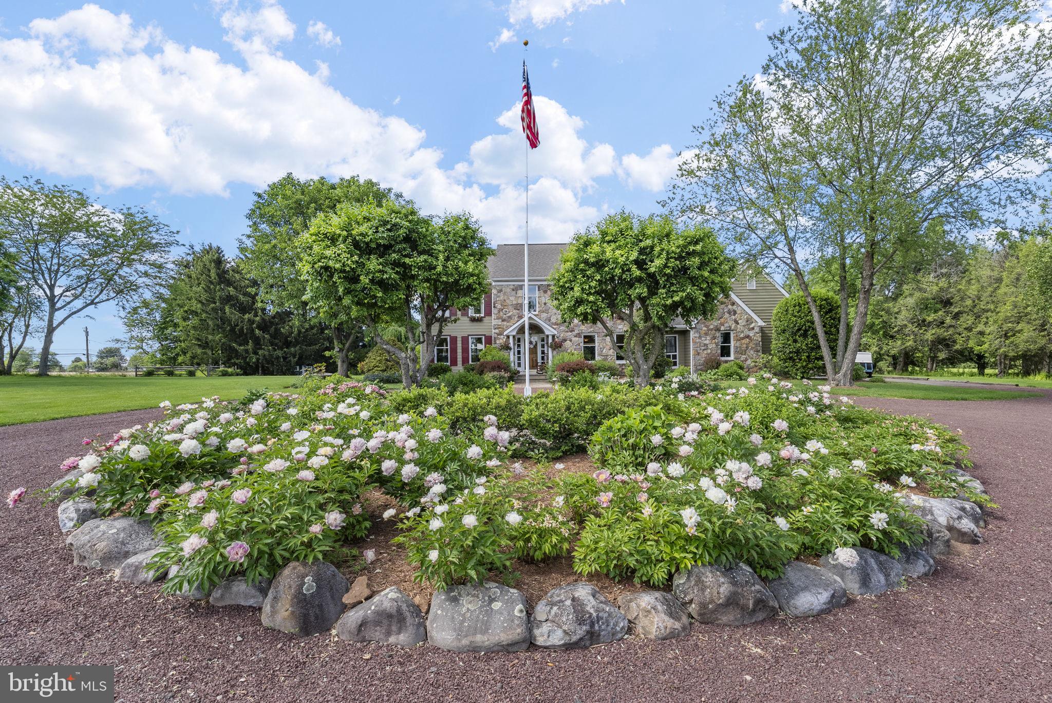 125 Mine Road Pennington, NJ 08534 - Photo 35 of 36 a front view of a house with a yard and fountain in middle