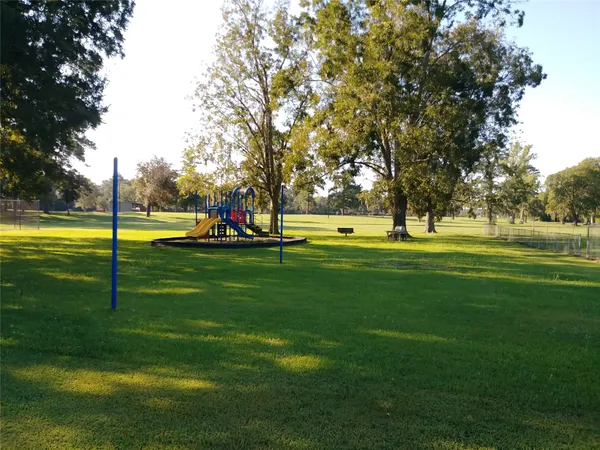 a view of a park with swings and slides