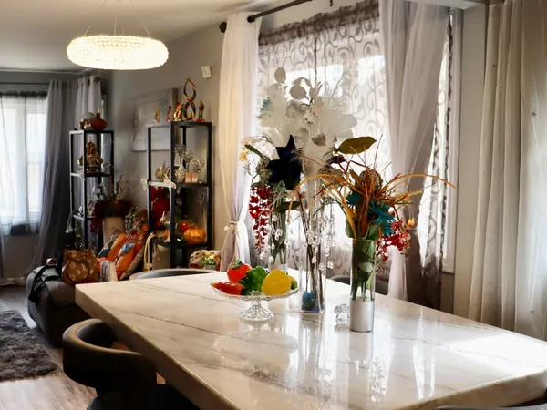 a view of a dining room with furniture and a potted plant