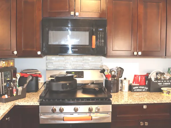 a kitchen with kitchen island granite countertop counter top space and cabinets