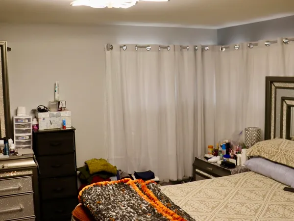 a bedroom with a bed and a dresser