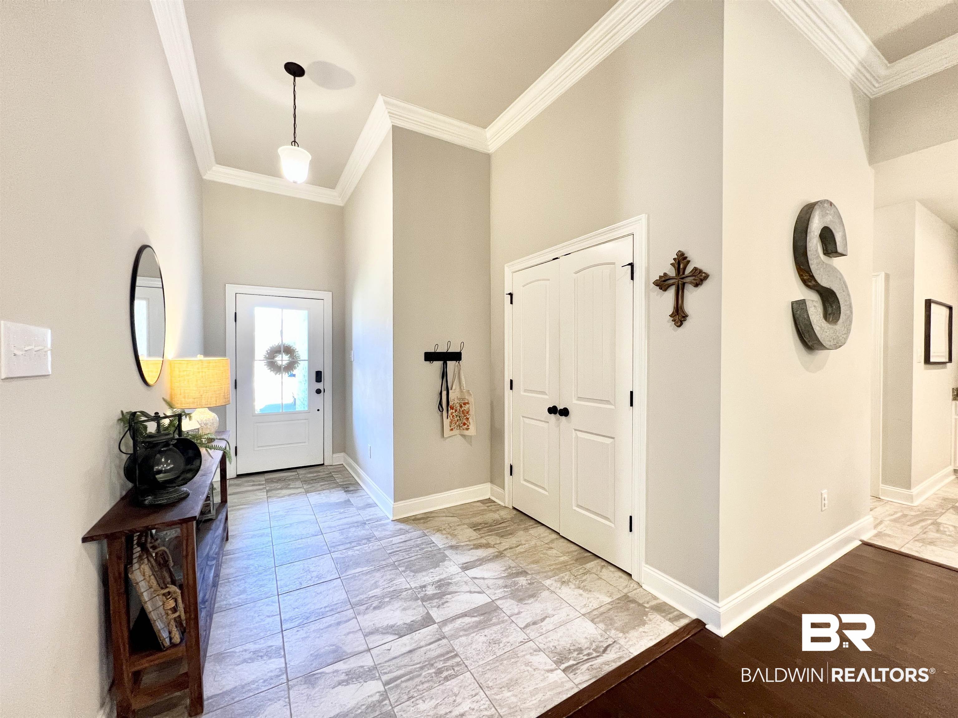 32290 Calder Court Daphne, AL 36527 - Photo 9 of 59 Foyer featuring crown molding, light hardwood / wood-style flooring, and a high ceiling