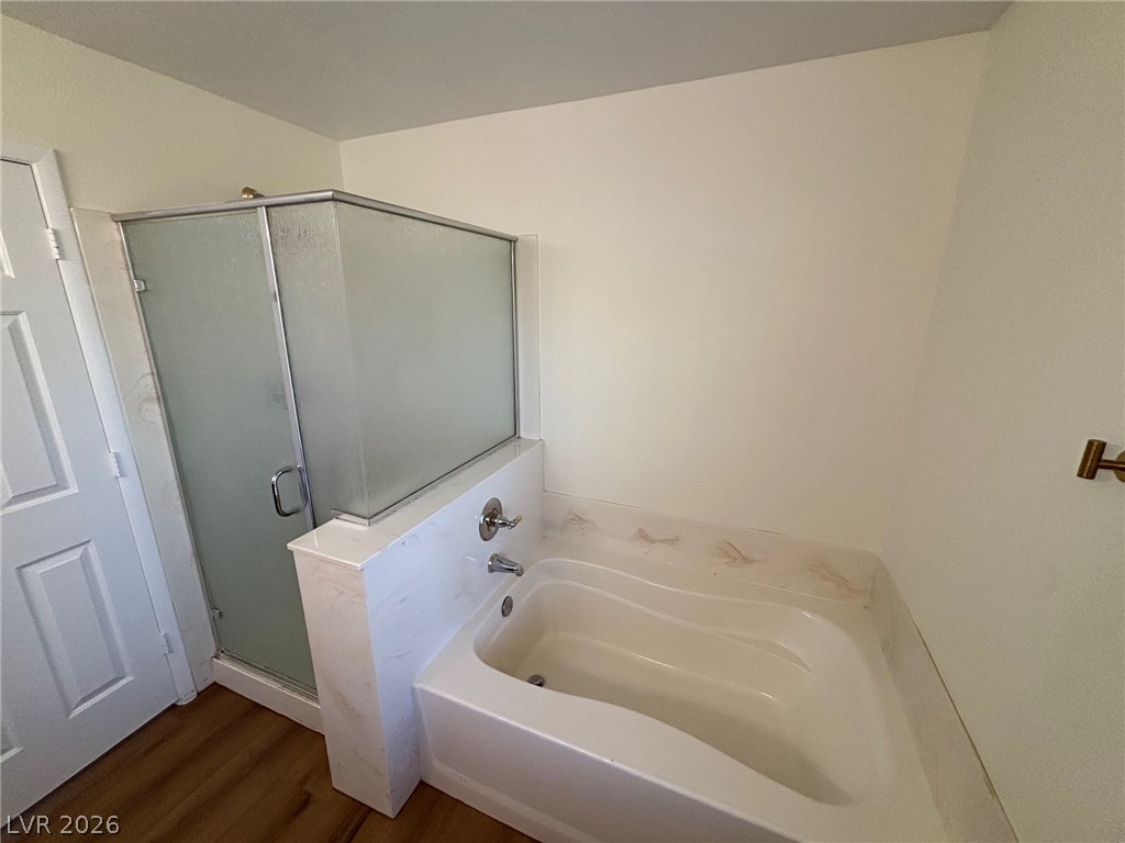 4900 Naff Ridge Drive Las Vegas, NV 89131 - Photo 13 of 21 A well-appointed bath features a shower enclosure and a built-in tub, ready for relaxation.