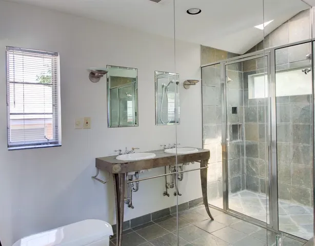 a bathroom with a sink toilet and shower