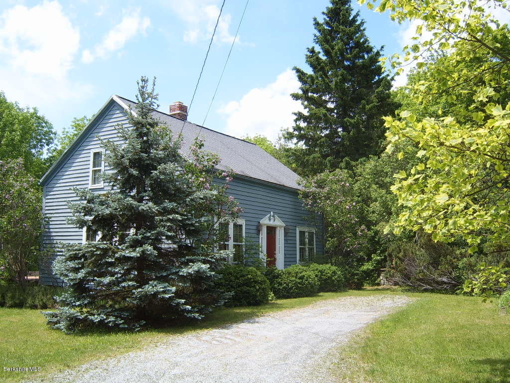 1191 George Carter Road Becket, MA 01223 - Photo 1 of 38 a front view of a house with garden