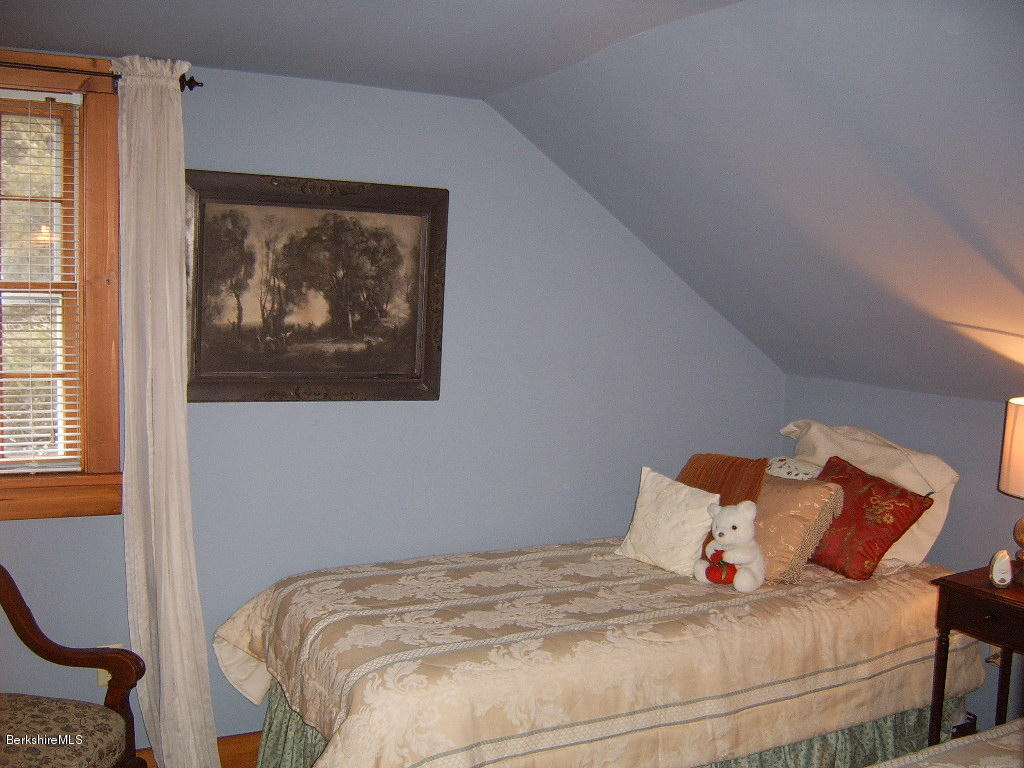 1191 George Carter Road Becket, MA 01223 - Photo 29 of 38 a bedroom with a bed and a painting on the wall