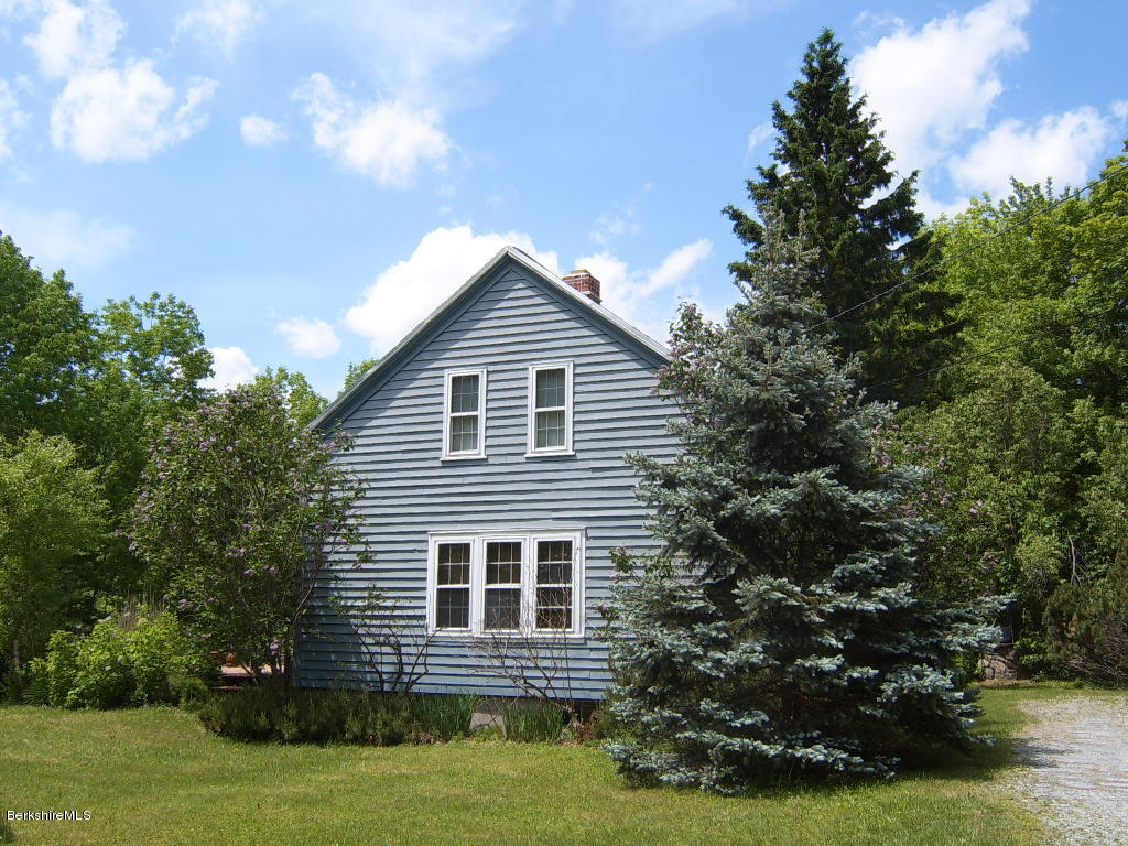 1191 George Carter Road Becket, MA 01223 - Photo 4 of 38 a house view with a garden space
