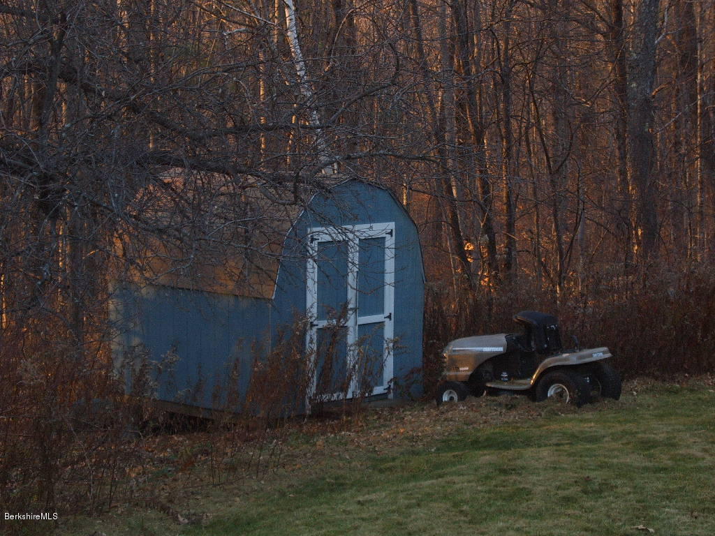 1191 George Carter Road Becket, MA 01223 - Photo 34 of 38 a backyard of a house with table and chairs