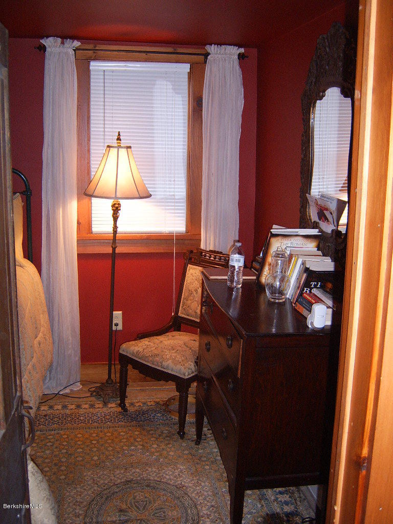 1191 George Carter Road Becket, MA 01223 - Photo 7 of 38 a room with a chair and a mirror