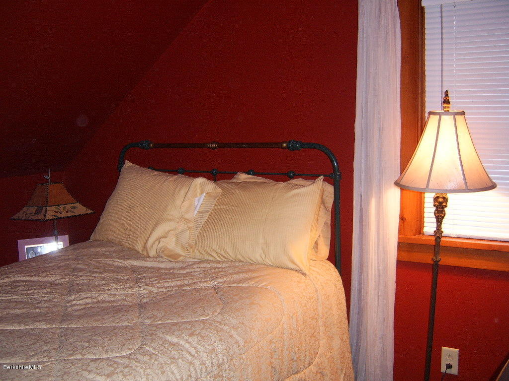1191 George Carter Road Becket, MA 01223 - Photo 8 of 38 a large bed sitting in a bedroom next to a window