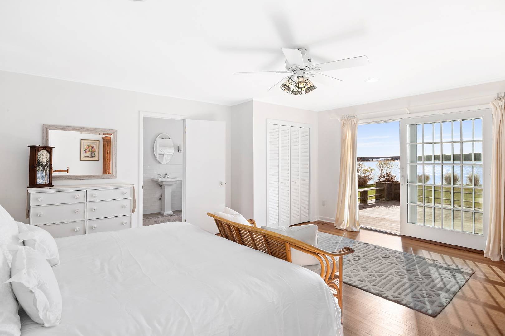 69 Ferry Road Sag Harbor, NY 11963 - Photo 11 of 17 a bedroom with a large bed and a chandelier