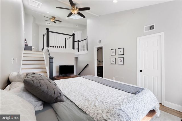 a bedroom with a large bed and a fireplace