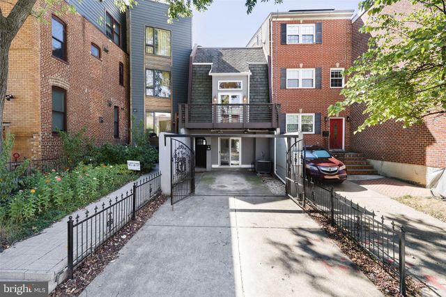 a view of a brick house with many windows
