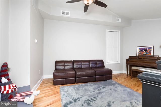 a living room with furniture and a piano