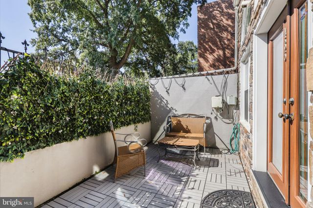 a view of balcony with two chairs and a potted plant
