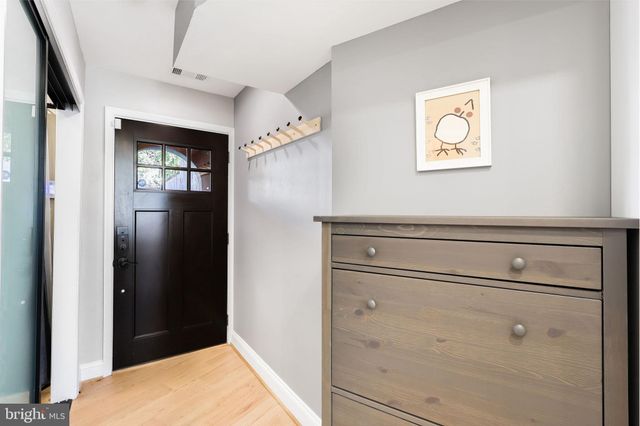 a view of hallway with wooden floor
