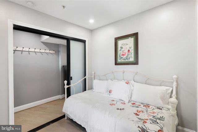 a bedroom with a large bed and a lamp