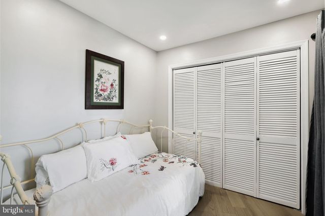 a bedroom with a bed and a wall painting