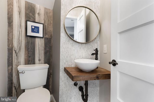 a bathroom with a toilet a sink and a mirror