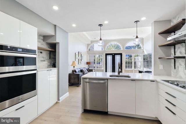 a kitchen with stainless steel appliances granite countertop a stove and a refrigerator