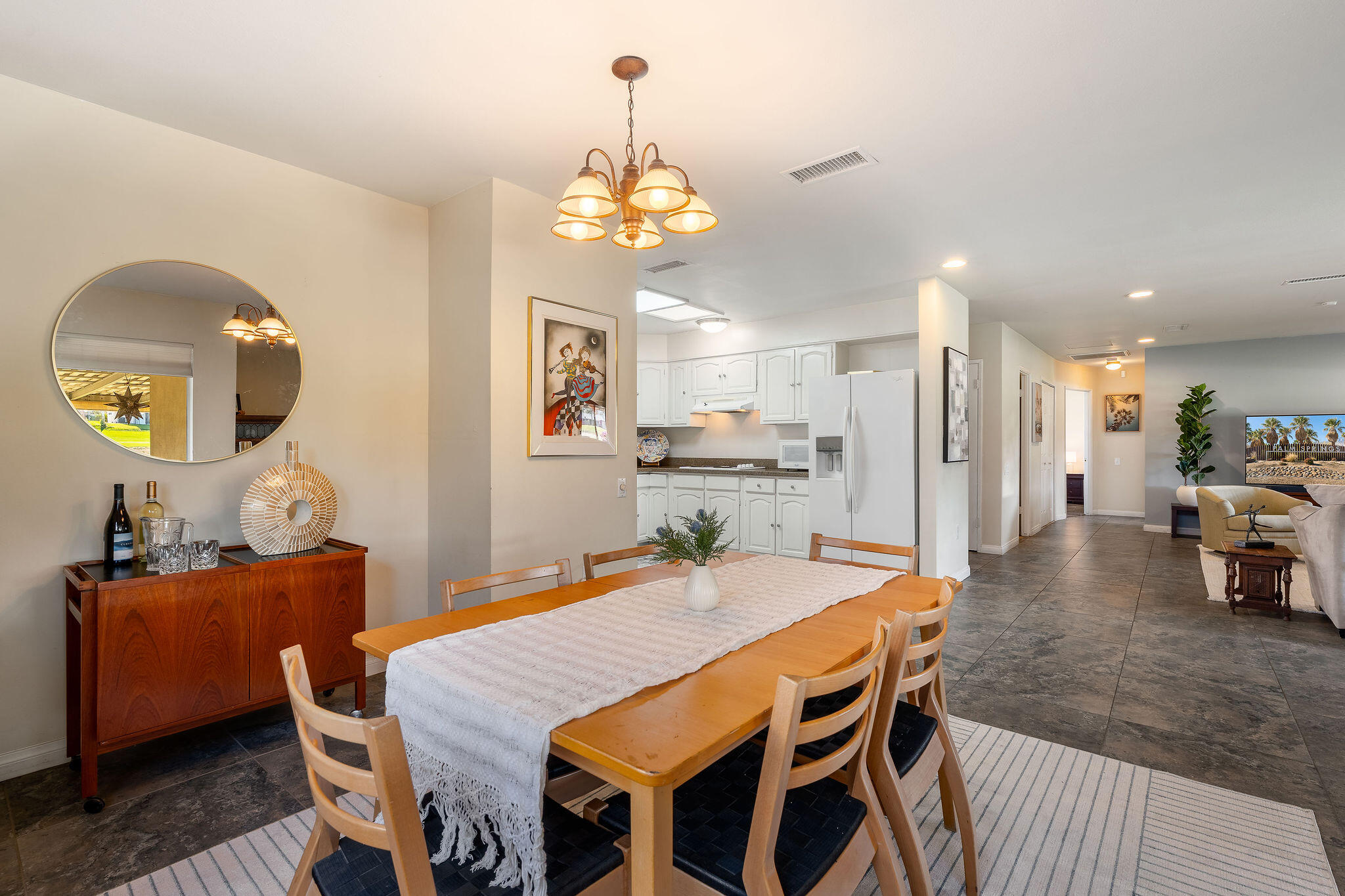 42735 Kansas Street Palm Desert, CA 92211 - Photo 15 of 48 a dining room with a table or chandelier and a wooden floor