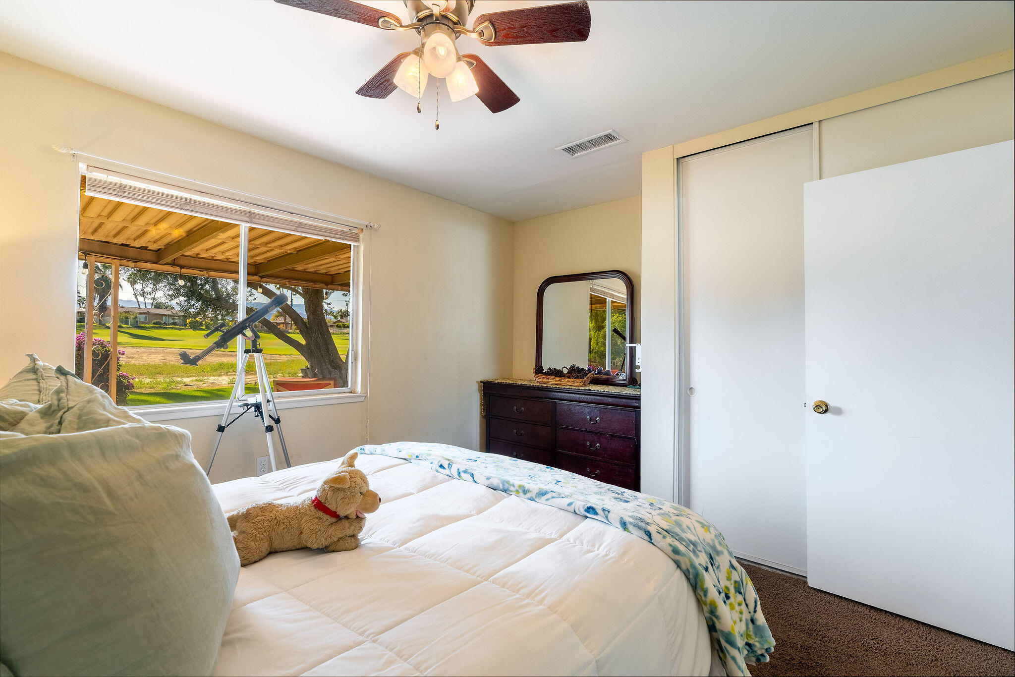 42735 Kansas Street Palm Desert, CA 92211 - Photo 28 of 48 a bedroom with a bed and a chandelier