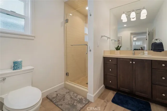 a spacious bathroom with a toilet a sink a mirror and vanity