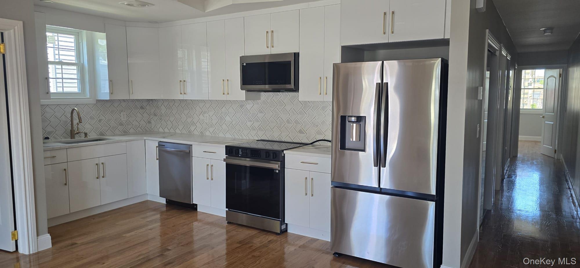 108-33 164th Street Queens, NY 11433 - Photo 11 of 20 a kitchen with stainless steel appliances a refrigerator sink and microwave