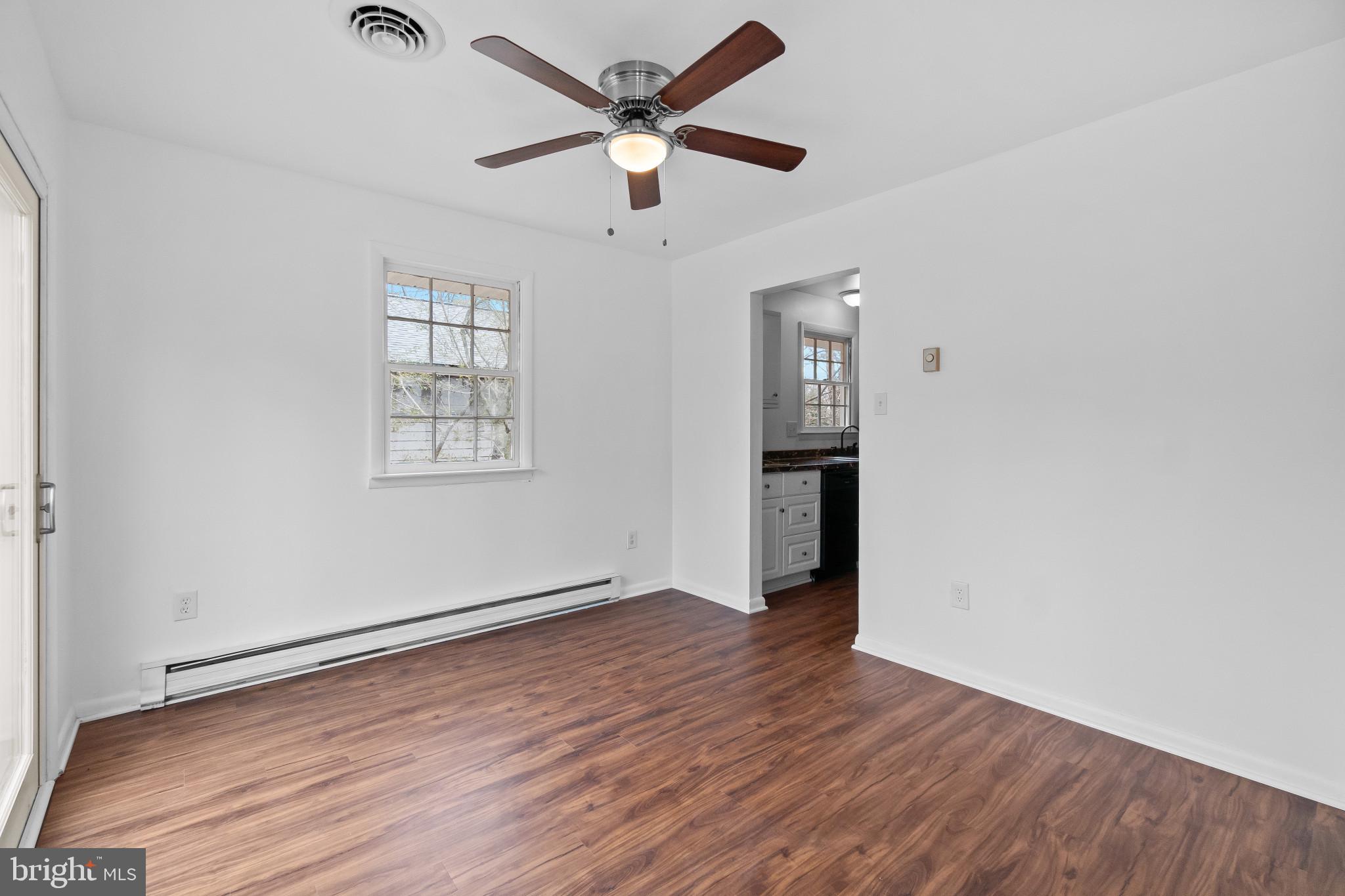 981 Westway Annapolis, MD 21409 - Photo 7 of 38 an empty room with wooden floor chandelier fan and windows