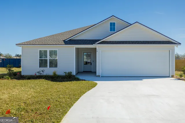 a front view of a house with a yard