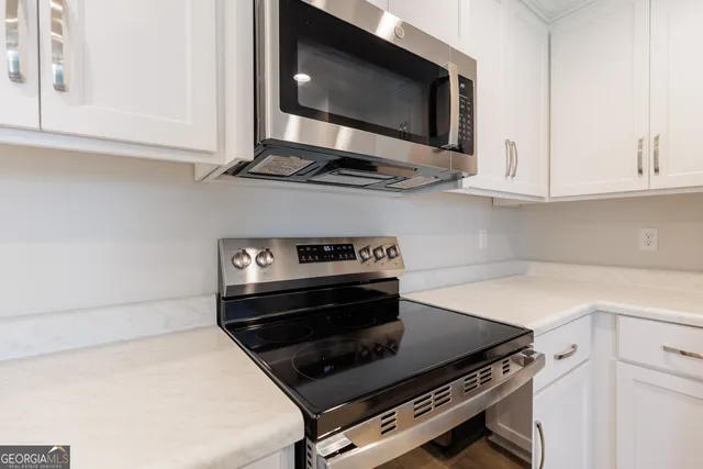 a kitchen with stainless steel appliances a stove and a microwave