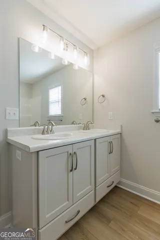 a bathroom with a double vanity sink and mirror