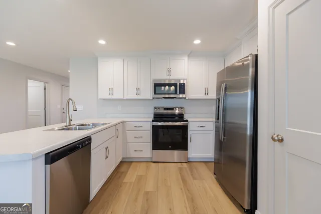 a kitchen with a refrigerator sink and stove