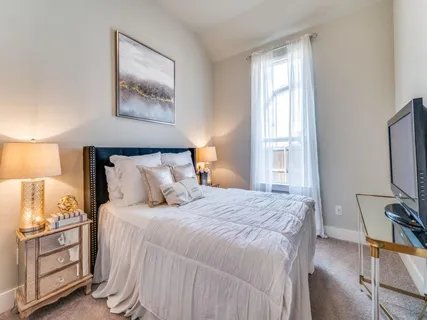 a bedroom with bed and window