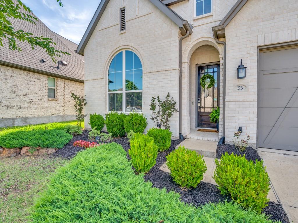 2724 Eccleston Street Celina, TX 75009 - Photo 2 of 29 a front view of a house with garden
