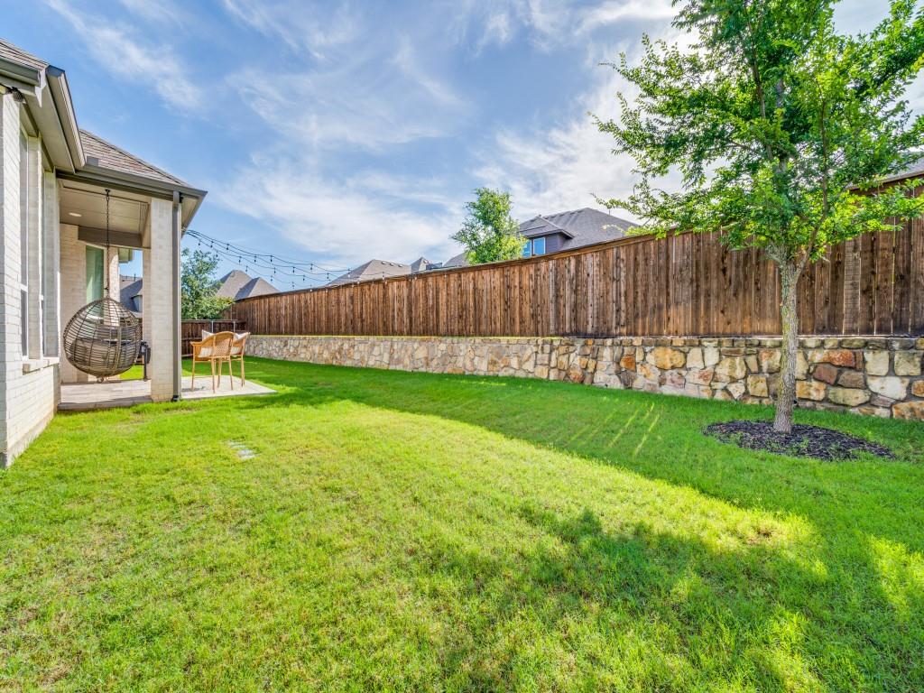 2724 Eccleston Street Celina, TX 75009 - Photo 25 of 29 a view of a backyard with table and chairs and wooden fence