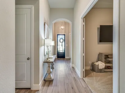 a view of a hallway with wooden floor windows and livingroom