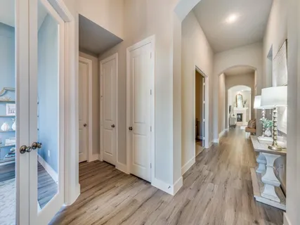 a view of a hallway with wooden floor and staircase