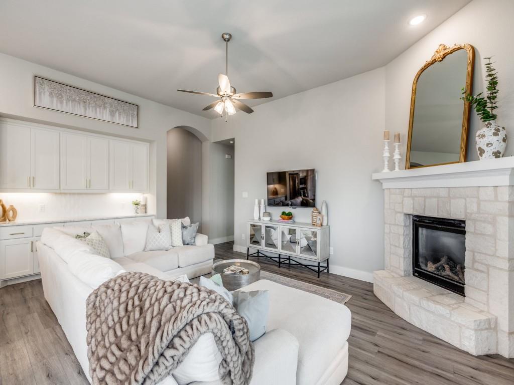 2724 Eccleston Street Celina, TX 75009 - Photo 6 of 29 a living room with furniture and a fireplace