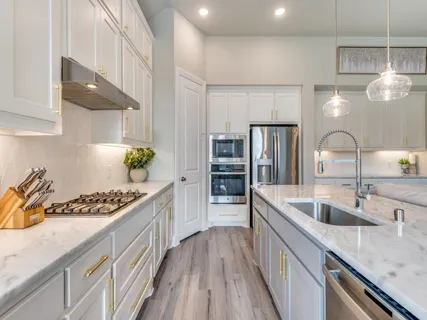 a kitchen with stainless steel appliances granite countertop a sink stove and refrigerator