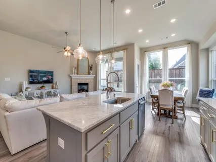 a open kitchen with sink stove and wooden floor