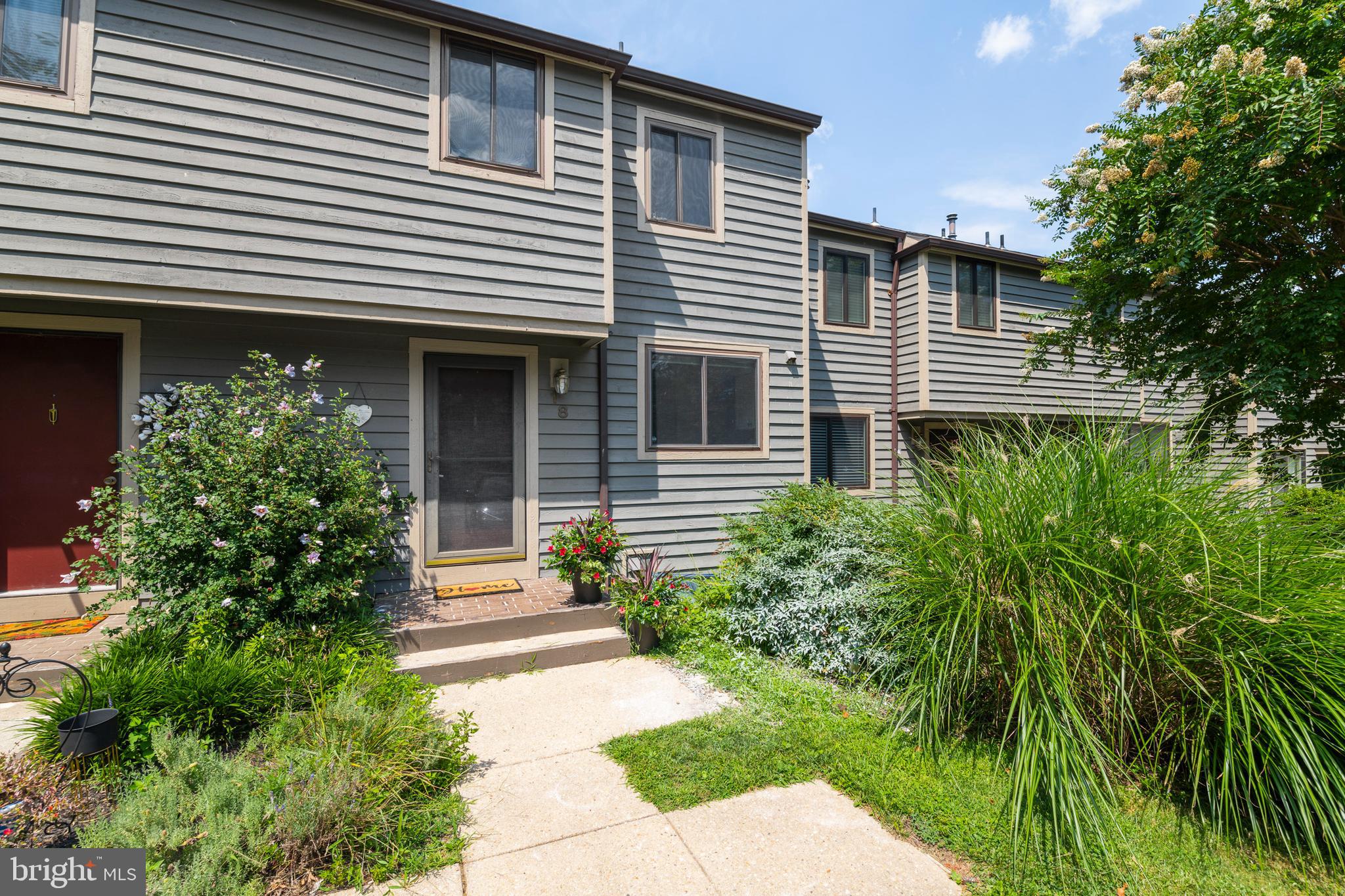 18 Stone Ridge Court, Unit 23 Baltimore, MD 21239 - Photo 1 of 19 a front view of a house with a garden