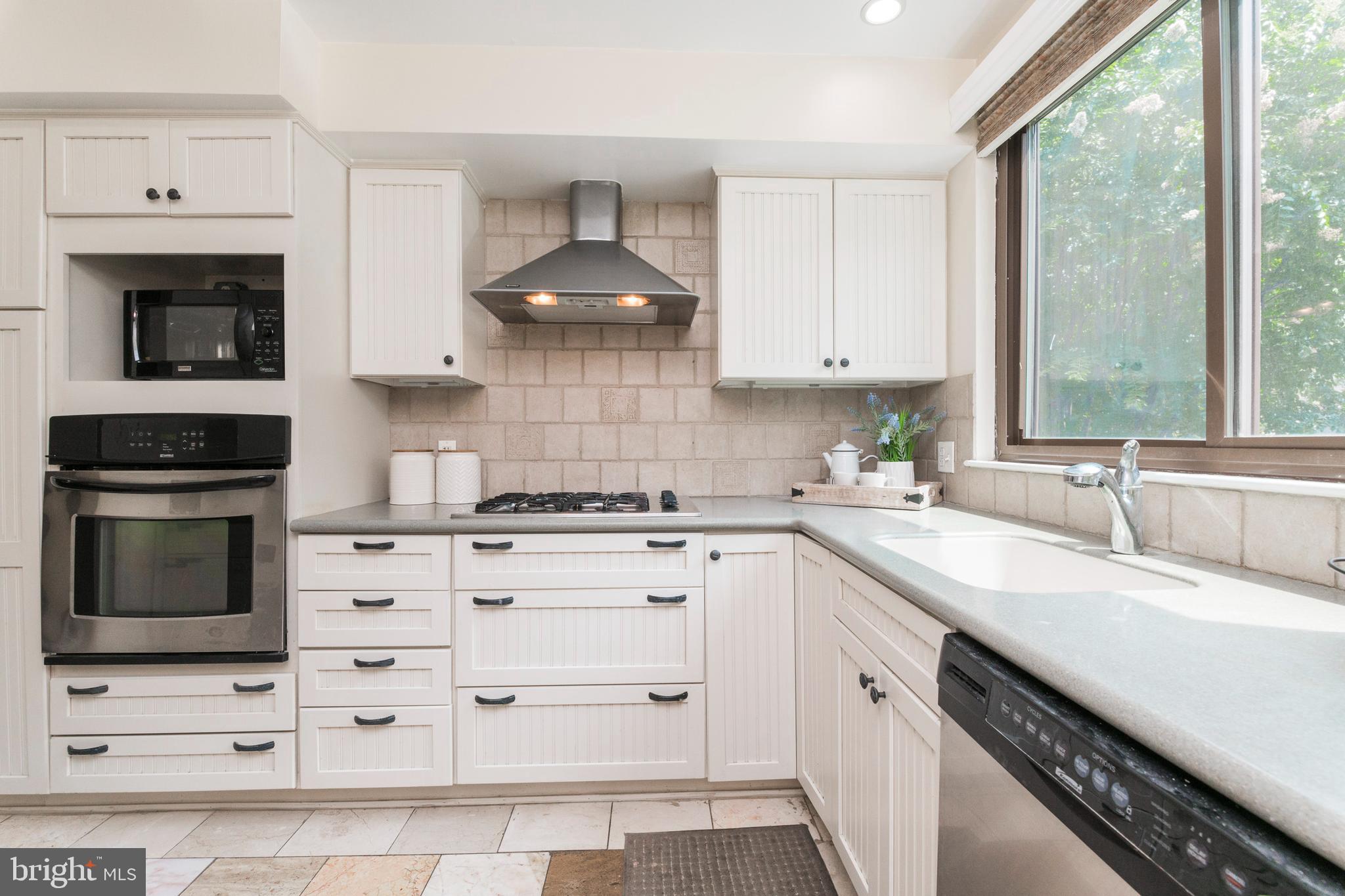 18 Stone Ridge Court, Unit 23 Baltimore, MD 21239 - Photo 2 of 19 a kitchen with granite countertop a sink stainless steel appliances and cabinets