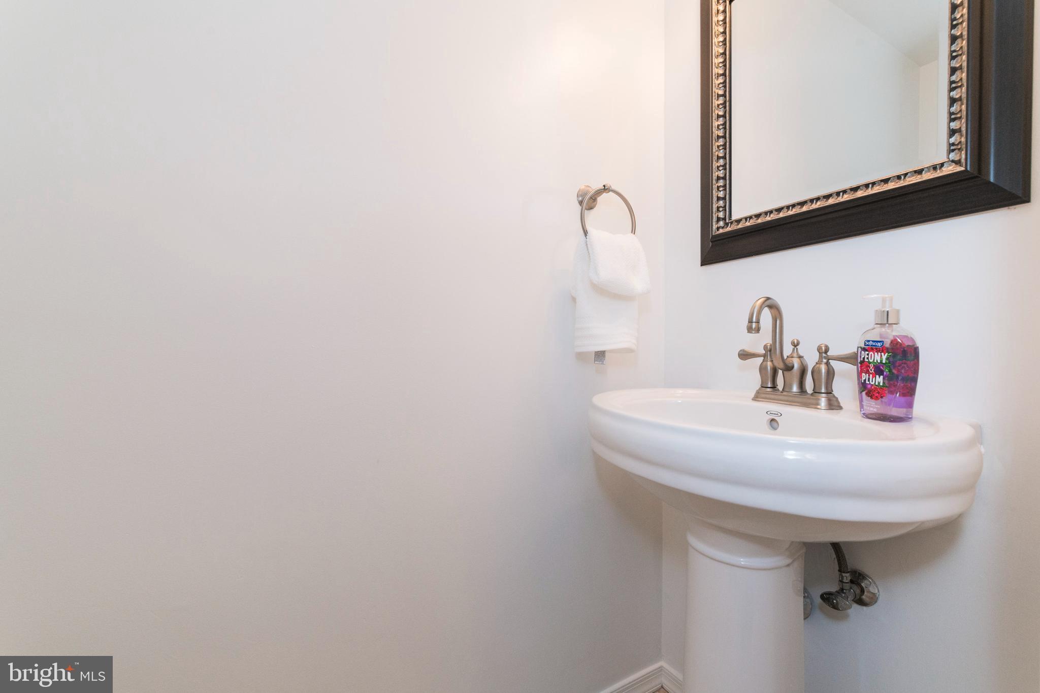 18 Stone Ridge Court, Unit 23 Baltimore, MD 21239 - Photo 11 of 19 a bathroom with a sink and a mirror