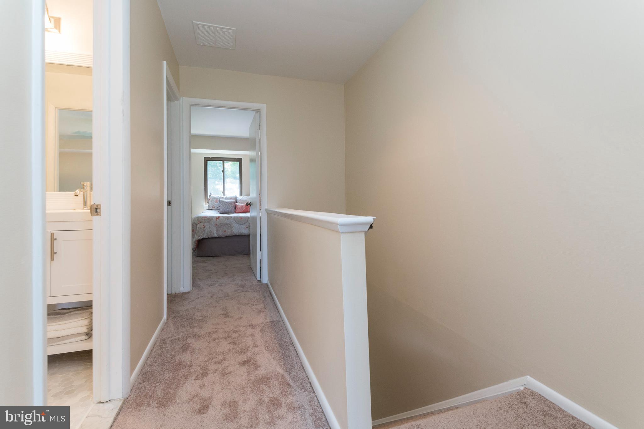 18 Stone Ridge Court, Unit 23 Baltimore, MD 21239 - Photo 13 of 19 a view of a hallway with a white walls