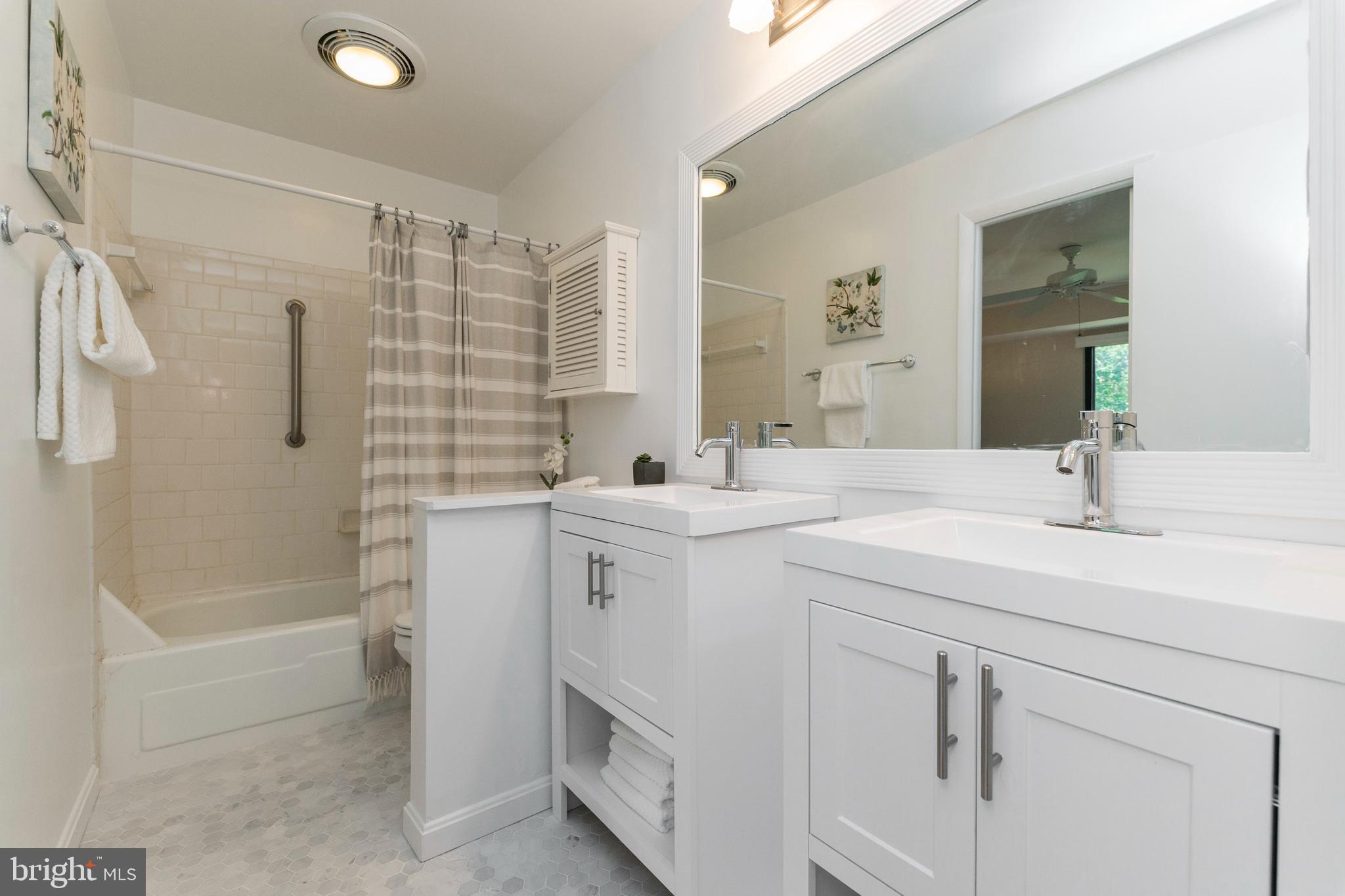 18 Stone Ridge Court, Unit 23 Baltimore, MD 21239 - Photo 14 of 19 a bathroom with a sink double vanity and tub